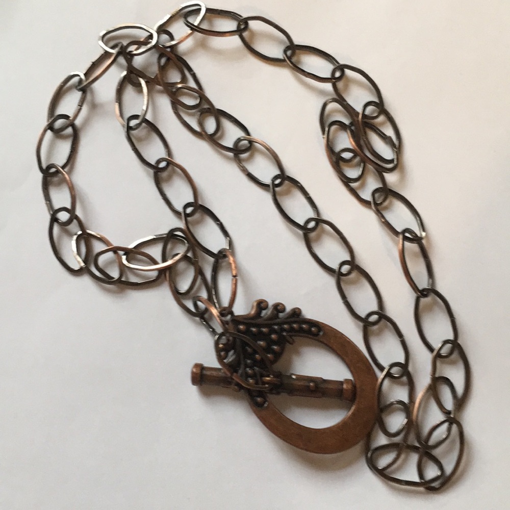 Copper toned necklace.  Clasp is pendant. Stylish